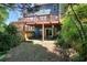 Backyard featuring a patio, wooden deck, and mature trees offering shade and privacy at 3716 Meeting St, Duluth, GA 30096