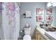 Charming bathroom featuring floral shower curtain, granite countertop and decorative wall art at 3716 Meeting St, Duluth, GA 30096