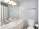 Simple bathroom with grey walls, granite vanity, and shower tub with curtain at 3716 Meeting St, Duluth, GA 30096