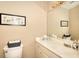 Cozy powder room featuring toilet, vanity with solid surface top, and framed artwork above the toilet at 3716 Meeting St, Duluth, GA 30096