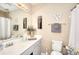 Well-lit bathroom with a vanity, toilet, shower, and decorative wall art at 3716 Meeting St, Duluth, GA 30096