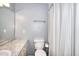 Simple bathroom with grey walls, granite vanity, and shower tub with curtain at 3716 Meeting St, Duluth, GA 30096