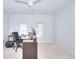 Light-filled bedroom featuring white walls, neutral carpet, a fan, and two windows at 3716 Meeting St, Duluth, GA 30096