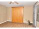 Bedroom with a Murphy bed, ceiling fan, wood-look flooring, and a window with blinds and curtains at 3716 Meeting St, Duluth, GA 30096