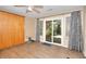 Bedroom with a Murphy bed, ceiling fan, wood-look flooring, and a sliding glass door at 3716 Meeting St, Duluth, GA 30096