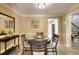 Inviting dining area with hardwood floors, round table, neutral paint color, and access to kitchen and stairs at 3716 Meeting St, Duluth, GA 30096