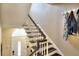 Stairway with coat hooks leading to a white front door with glass insert and black hardware at 3716 Meeting St, Duluth, GA 30096