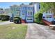 Charming multi-colored townhome with brick steps leading to a white front door and attached one car garage at 3716 Meeting St, Duluth, GA 30096