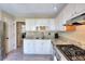 Traditional kitchen features white cabinets, granite countertops, and stainless steel appliances at 3716 Meeting St, Duluth, GA 30096