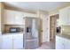Kitchen with stainless steel refrigerator, granite countertops, and white cabinets at 3716 Meeting St, Duluth, GA 30096