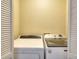 Enclosed laundry area featuring a front-load washer and dryer, providing convenience at 3716 Meeting St, Duluth, GA 30096