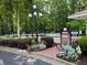 Community pool entrance with colorful flowers, security cameras, and gate access during posted hours at 3716 Meeting St, Duluth, GA 30096