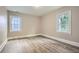 Spacious bedroom featuring hardwood floors, fresh neutral paint and two large windows at 1002 Ira Sw St, Atlanta, GA 30310