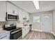 Modern kitchen featuring white cabinets, stainless steel appliances, and a bright window at 1002 Ira Sw St, Atlanta, GA 30310