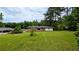 Large, well-maintained backyard with a view of the house and surrounding trees, ideal for outdoor activities at 1091 Luther Sw Dr, Mableton, GA 30126