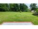 Expansive backyard with lush green grass and mature trees, offering a serene outdoor space at 1091 Luther Sw Dr, Mableton, GA 30126
