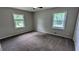 Spacious bedroom with two windows providing natural light, complemented by neutral walls and carpet at 1091 Luther Sw Dr, Mableton, GA 30126