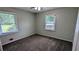 Bedroom featuring two windows, neutral gray walls, comfortable carpet, and a ceiling fan at 1091 Luther Sw Dr, Mableton, GA 30126