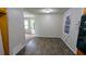 Dining room area featuring modern flooring and neutral paint, and views into the kitchen and the entryway at 1091 Luther Sw Dr, Mableton, GA 30126