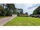 Charming brick home with a well-manicured lawn and a long driveway leading to an attached garage at 1091 Luther Sw Dr, Mableton, GA 30126