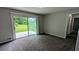 Living room showcasing sliding glass doors to the backyard, neutral carpet, and neutral paint at 1091 Luther Sw Dr, Mableton, GA 30126