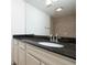 Bathroom vanity features granite counters, sink, updated faucet and large mirror at 1468 Briarwood Ne Rd # 2003, Atlanta, GA 30319