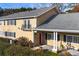 Charming home featuring a red door, black shutters, gray roof, and a cozy front porch seating area at 1468 Briarwood Ne Rd # 2003, Atlanta, GA 30319