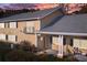 Charming home featuring a red door, black shutters, gray roof, and a cozy front porch seating area at 1468 Briarwood Ne Rd # 2003, Atlanta, GA 30319
