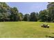 Lush green space featuring manicured lawn, mature trees, and picnic tables at 1468 Briarwood Ne Rd # 2003, Atlanta, GA 30319