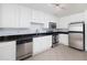 Well-equipped kitchen with white cabinets, stainless steel appliances, granite countertops, and tile flooring at 1468 Briarwood Ne Rd # 2003, Atlanta, GA 30319