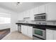 Bright kitchen featuring stainless steel appliances, sleek black countertops, white cabinets, and tile floors at 1468 Briarwood Ne Rd # 2003, Atlanta, GA 30319