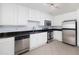 Modern kitchen with stainless steel appliances, granite counters, white cabinets, and tile flooring at 1468 Briarwood Ne Rd # 2003, Atlanta, GA 30319