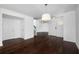 Spacious living room featuring hardwood floors, access to front door, and staircase to upper level at 1468 Briarwood Ne Rd # 2003, Atlanta, GA 30319