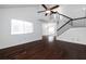 Bright living room featuring a high ceiling, fan, staircase, hardwood floors, and comfortable neutral furniture at 1468 Briarwood Ne Rd # 2003, Atlanta, GA 30319