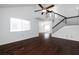 Bright living room with high ceilings, ceiling fan, dark wood floors, and a view into the dining room at 1468 Briarwood Ne Rd # 2003, Atlanta, GA 30319