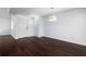 Minimalist living room with hardwood floors, white walls, and a view of the front door at 1468 Briarwood Ne Rd # 2003, Atlanta, GA 30319