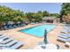Community pool with ample seating, lounge chairs and tables, surrounded by mature trees at 1468 Briarwood Ne Rd # 2003, Atlanta, GA 30319