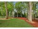 Large backyard featuring grassy area, trees, and trampoline behind a fenced yard at 1768 San Andra Dr, Marietta, GA 30062