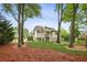 Inviting backyard with a covered porch, fenced yard, mature trees, and lush green grass at 1768 San Andra Dr, Marietta, GA 30062