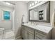 Bathroom with a gray vanity with a marble top, a large mirror, and a separate shower at 1768 San Andra Dr, Marietta, GA 30062