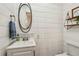 Stylish half bathroom with shiplap walls, updated vanity, and modern fixtures at 1768 San Andra Dr, Marietta, GA 30062