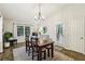 Comfortable dining room with wood floors, modern chandelier and views to outside at 1768 San Andra Dr, Marietta, GA 30062