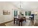 Inviting dining room with wood floors, pendant lighting and bright windows at 1768 San Andra Dr, Marietta, GA 30062