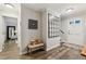 Welcoming entryway with hardwood floors, bench seating, and decorative mirror, leading to the rest of the home at 1768 San Andra Dr, Marietta, GA 30062