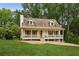 Charming home featuring a cozy front porch, well-manicured lawn, and beautiful landscaping at 1768 San Andra Dr, Marietta, GA 30062