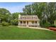 Charming home featuring a cozy front porch, well-manicured lawn, and beautifully landscaped surroundings at 1768 San Andra Dr, Marietta, GA 30062