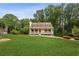 Inviting single-Gathering home with a rocking chair front porch and lush greenery at 1768 San Andra Dr, Marietta, GA 30062
