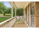 Charming front porch featuring a wooden swing, decorative pillows, and natural light at 1768 San Andra Dr, Marietta, GA 30062