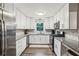 Contemporary kitchen with white cabinetry, granite countertops, stainless steel appliances, and hardwood floors at 1768 San Andra Dr, Marietta, GA 30062