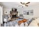 Spacious living room featuring stone fireplace, ceiling fan, and stylish decor, providing a cozy atmosphere at 1768 San Andra Dr, Marietta, GA 30062
